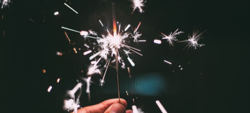 person holding a lit sparkler