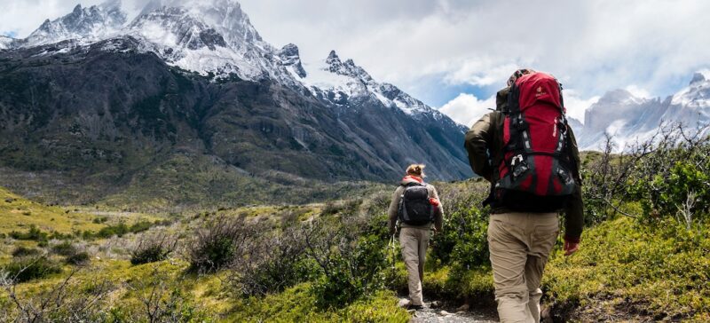 two people hiking to a mountain