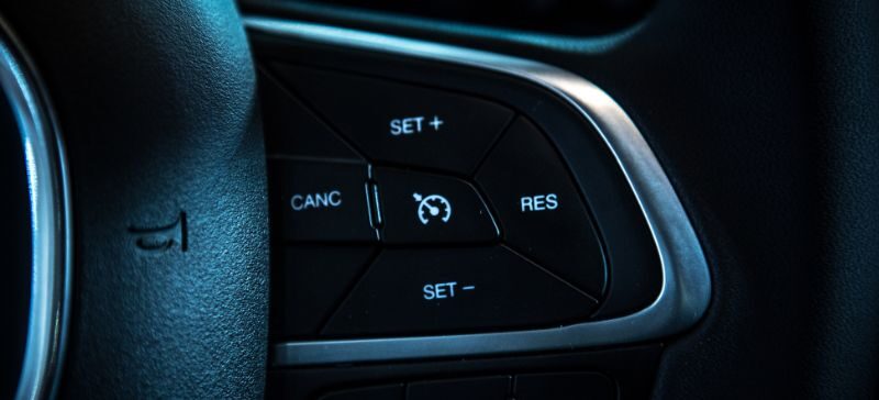 Cruise controls on a black steering wheel