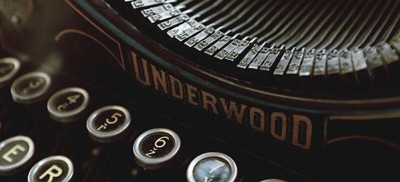 Closeup of old-fashioned black typewriter with round letter keys