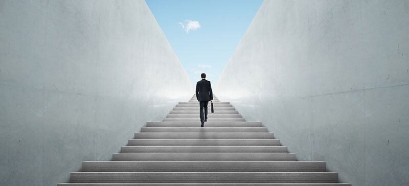 Man walkng up infinite stairway